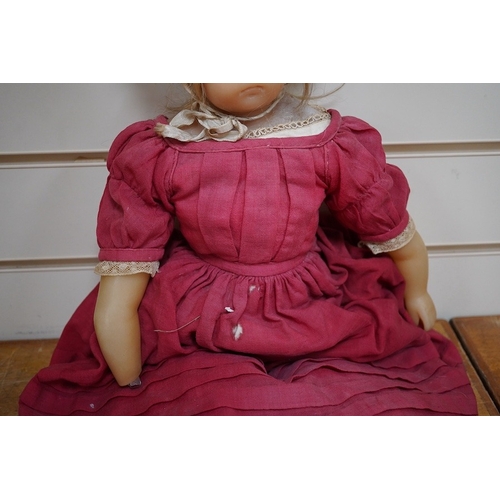 329 - A 19th century poured wax shoulder doll, paperweight eyes and jointed limbs, 60cm.  Condition - some... 