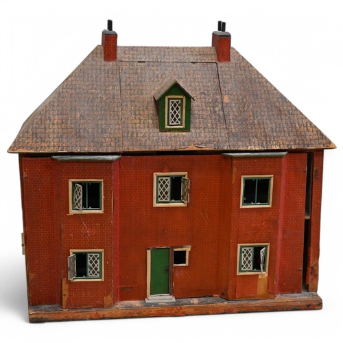 332 - A 1920s/30s commercially produced dolls house, possibly by Tri-ang, of plywood construction, overlai... 