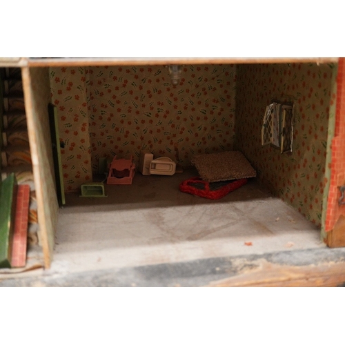 332 - A 1920s/30s commercially produced dolls house, possibly by Tri-ang, of plywood construction, overlai... 