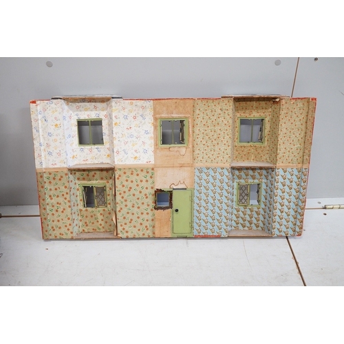 332 - A 1920s/30s commercially produced dolls house, possibly by Tri-ang, of plywood construction, overlai... 