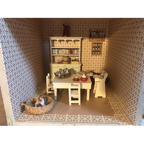 333 - A late 19th century doll's house, with a single front opening panel, incorporating eight internal ro... 