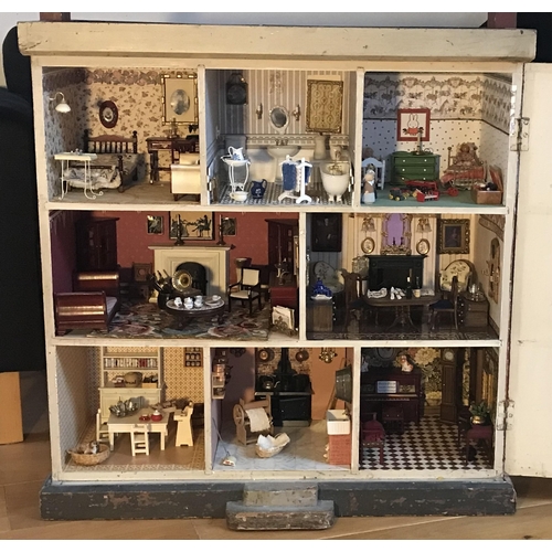 333 - A late 19th century doll's house, with a single front opening panel, incorporating eight internal ro... 