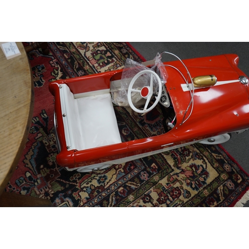 336 - A tinplate Tri-ang T65 pedal car, based on a Ford Zephyr, with vinyl padded seat, working steering, ... 