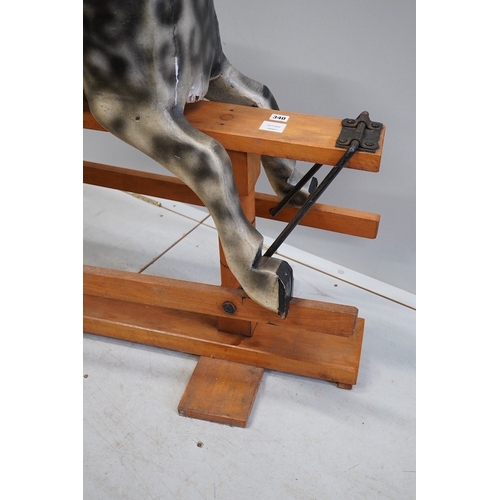 340 - An early 20th century dapple grey rocking horse, on later trestle base, length 132cm. Condition - fa... 