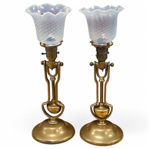 372 - A pair of brass Pullman lamps with gimbal stems and Vaseline glass shades, modelled for wall mountin... 