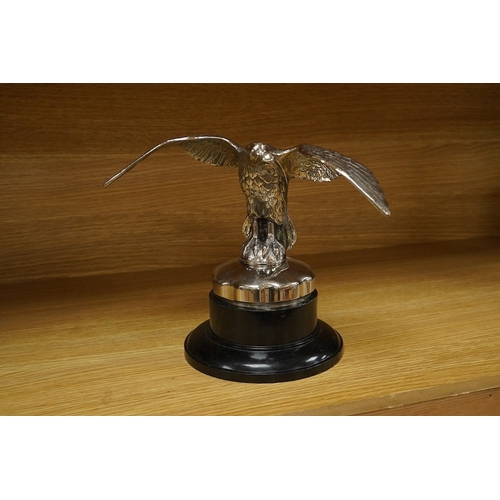 376 - A large chromed eagle car mascot, mounted on a large radiator cap and turned socle, height 21.5cm. C... 