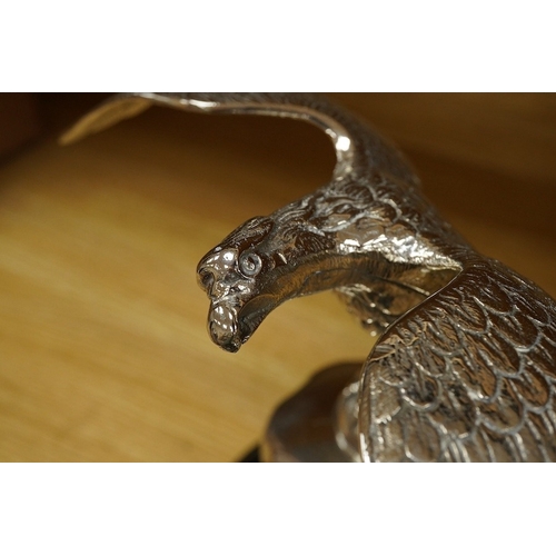 376 - A large chromed eagle car mascot, mounted on a large radiator cap and turned socle, height 21.5cm. C... 