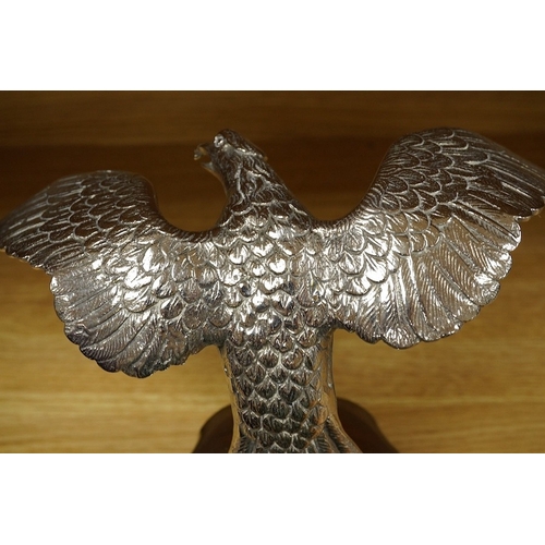 376 - A large chromed eagle car mascot, mounted on a large radiator cap and turned socle, height 21.5cm. C... 