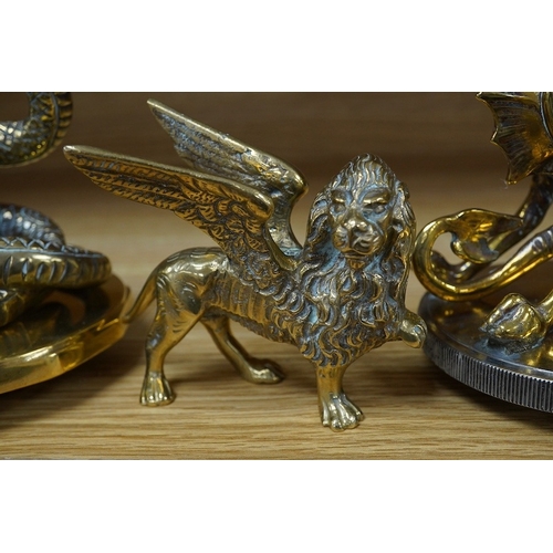 388 - Three brass radiator mascots; one of a coiled snake, one of a dragon, and a winged lion, tallest 18c... 