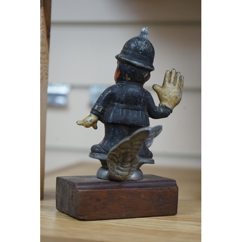 390 - A cold painted cast aluminium car mascot in the form of a caricature of a policeman on associated ch... 