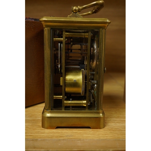 410 - A French brass cased repeating carriage clock, striking on a bell, with key and case, 16cm high. Con... 