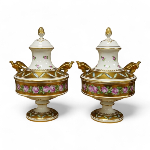 411 - A pair of Dresden porcelain vases/urns, hand painted and gilded, numbered 11914 to the base, 24cm hi... 