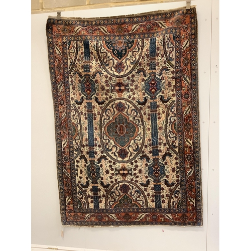 42 - A North West Persian ivory ground rug, 200 x 142cm. Condition - fair