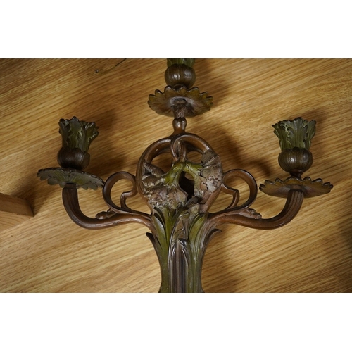 428 - A pair of French patinated spelter floral painted Art Nouveau two branch, three light candelabra, 40... 