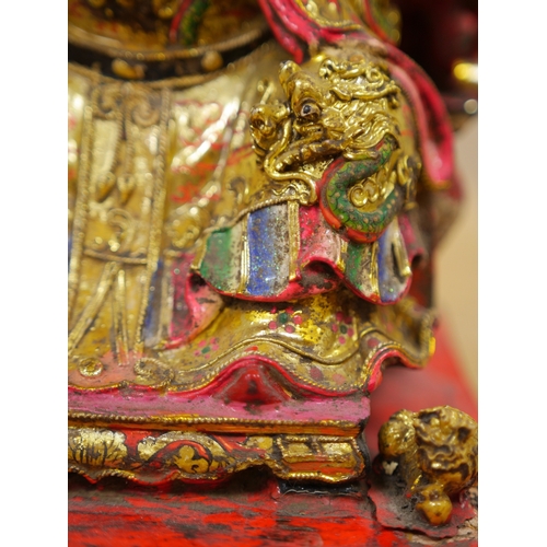 457 - A Chinese gilt and painted composition figure of a seated immortal, 31cm tall. Condition - poor to f... 