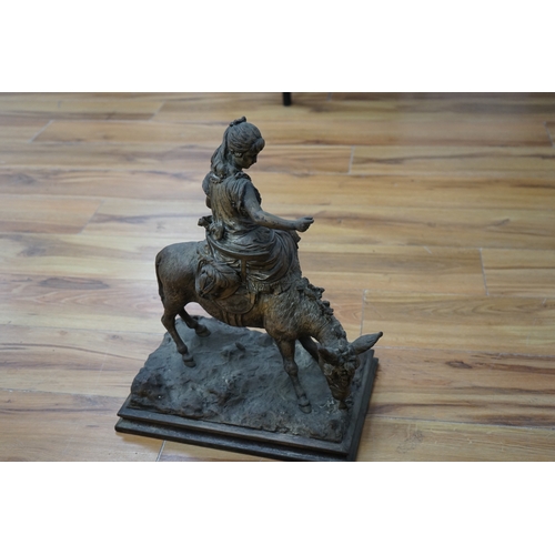 464 - A silvered resin figure of a girl on a donkey, 45cm high. Condition - poor