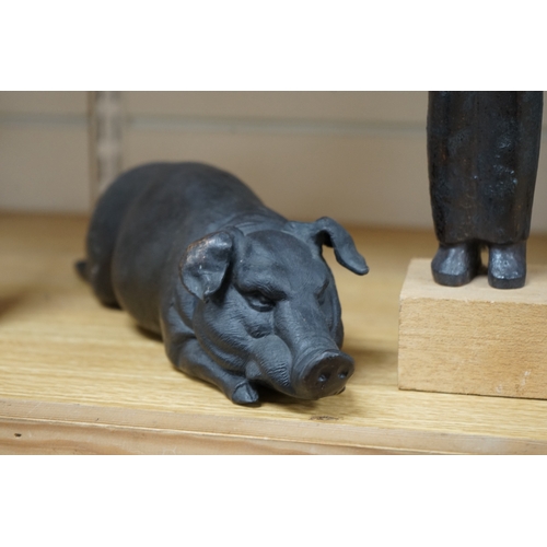 473 - A bronze model of a recumbent pig, another cast iron model of twin heads and bronze maquette of a fi... 