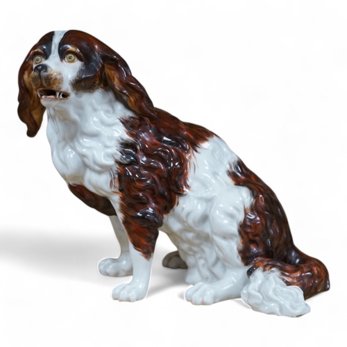 484 - A Sitzendorf porcelain model of seated Spaniel, 21cm. Condition - repaired paw