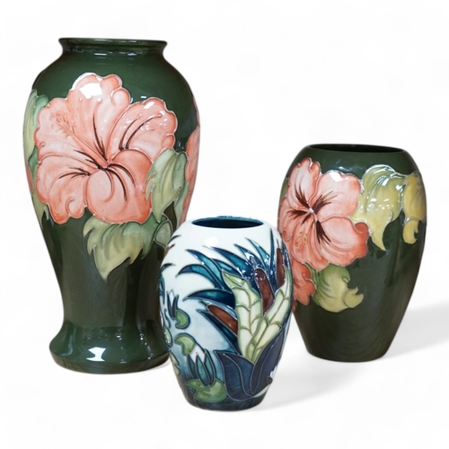 491 - Three 1990's Moorcroft vases, Hibiscus and Lamia pattern, tallest 26cm. Condition - good