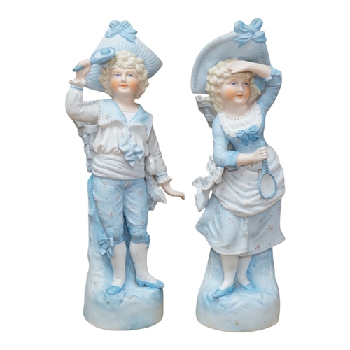 494 - A pair of late 19th century German figurative bisque spill vases, 30cm high. Condition - good