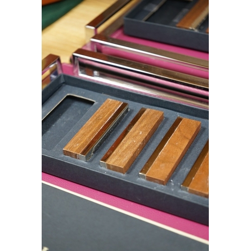 505 - David Linley, two chrome and leather square trays together with two incomplete sets of menu holders.... 