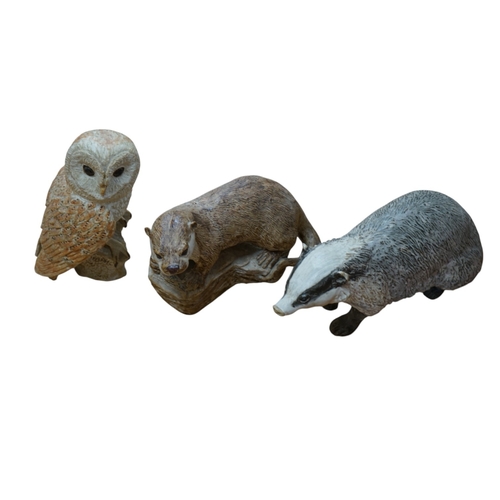 509 - Audrey Carter, three studio pottery animal models, an owl, otter and badger, 37cm. Condition - good... 