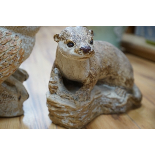 509 - Audrey Carter, three studio pottery animal models, an owl, otter and badger, 37cm. Condition - good... 