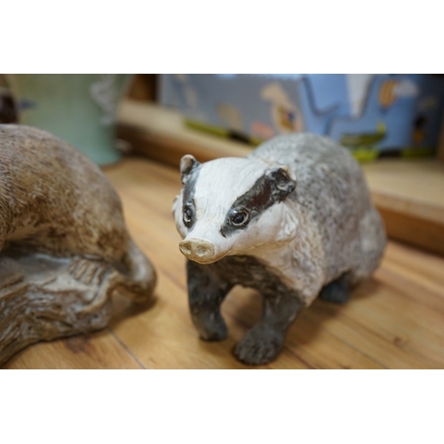 509 - Audrey Carter, three studio pottery animal models, an owl, otter and badger, 37cm. Condition - good... 