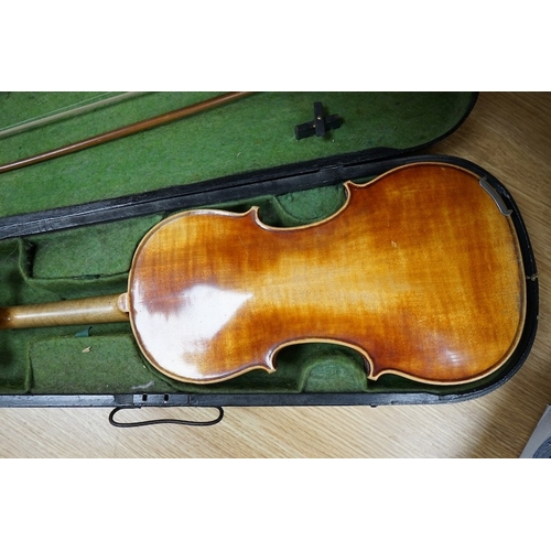 518 - A 19th century cased violin and bow, body of violin 35.5cm long. Condition - needs restringing... 