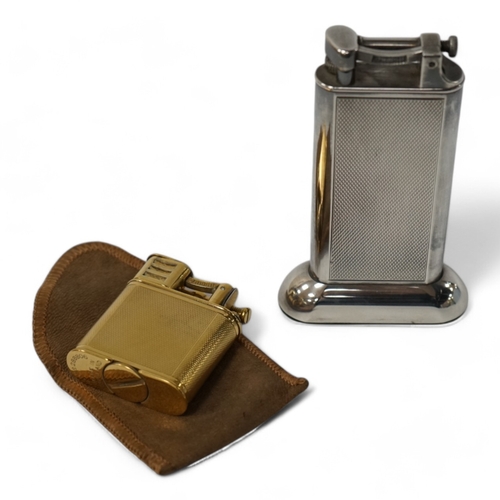 530 - Two Dunhill lighters to include a plated table lighter, largest 10cm high. Condition - fair to good,... 