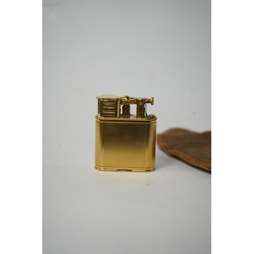 530 - Two Dunhill lighters to include a plated table lighter, largest 10cm high. Condition - fair to good,... 