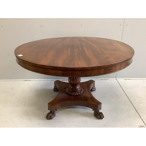 70 - An early Victorian mahogany circular tilt top breakfast table, on a pillar and flat quadruple platfo... 