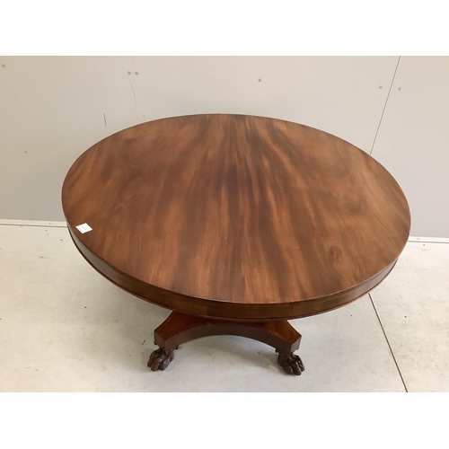 70 - An early Victorian mahogany circular tilt top breakfast table, on a pillar and flat quadruple platfo... 