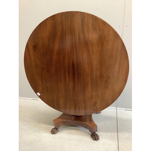 70 - An early Victorian mahogany circular tilt top breakfast table, on a pillar and flat quadruple platfo... 