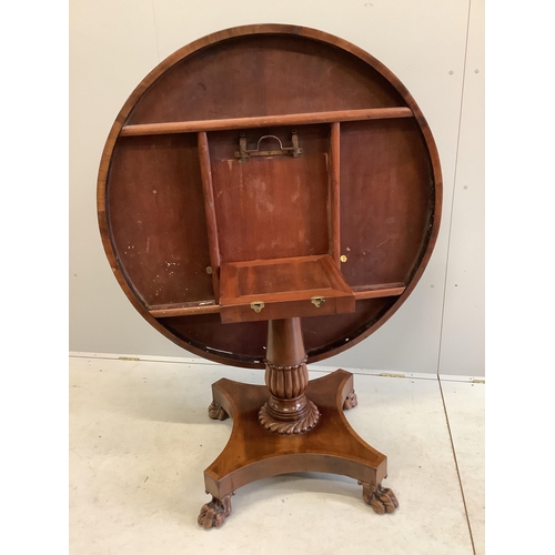 70 - An early Victorian mahogany circular tilt top breakfast table, on a pillar and flat quadruple platfo... 