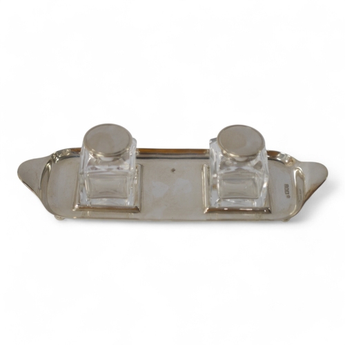 828 - An Edwardian silver rectangular inkstand, with two silver mounted glass wells, Josiah Williams & Co,... 