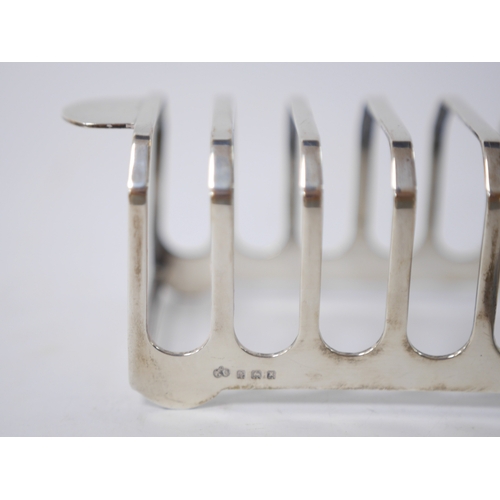 848 - A George VI silver seven bar toast rack, by Elkington & Co, Birmingham, 1947, 14.9cm, together with ... 