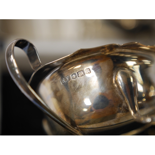 850 - A cased Elizabeth II silver sauce boat and spoon, by Viners Ltd, Sheffield, 1952/5 and one other sil... 