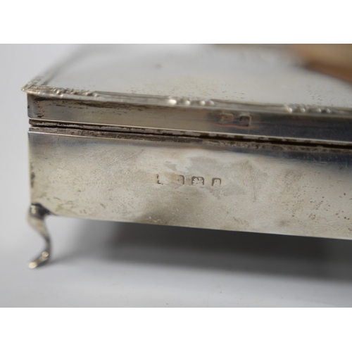 856 - A George V silver mounted rectangular cigarette box, London, 1926, 25.9cm, together with an Edwardia... 