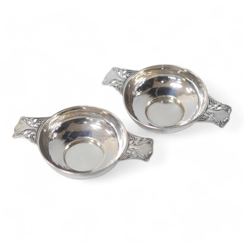 862 - A pair of Edwardian Art Nouveau silver dishes of quaich form, with pierced handles, by W.G. Connell,... 