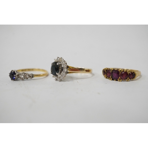 911 - A group of three rings, comprising: a sapphire and diamond cluster ring, size M1/2, stamped 14K and ... 