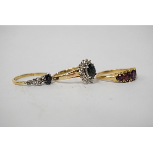 911 - A group of three rings, comprising: a sapphire and diamond cluster ring, size M1/2, stamped 14K and ... 