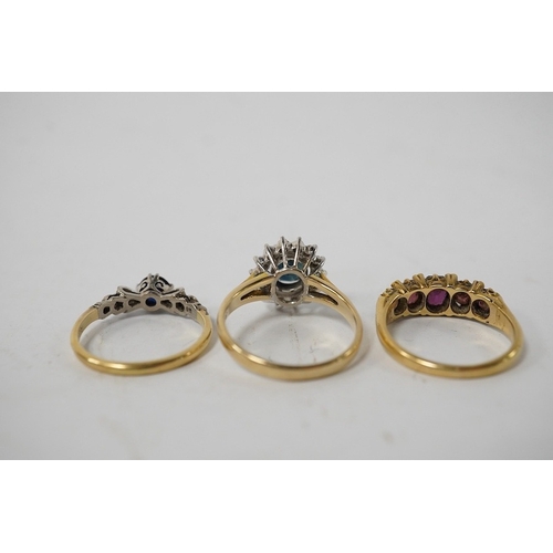 911 - A group of three rings, comprising: a sapphire and diamond cluster ring, size M1/2, stamped 14K and ... 