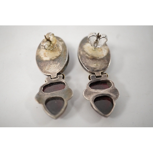 918 - A pair of modern yellow and white metal mounted three stone oval cabochon garnet set drop earrings, ... 