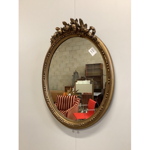 93 - An oval gilt framed wall mirror, width 47cm, height 60cm. Condition - fair