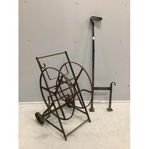 94 - A wrought iron boot scraper, height 122cm together with a hose reel stand. Condition - poor to fair... 