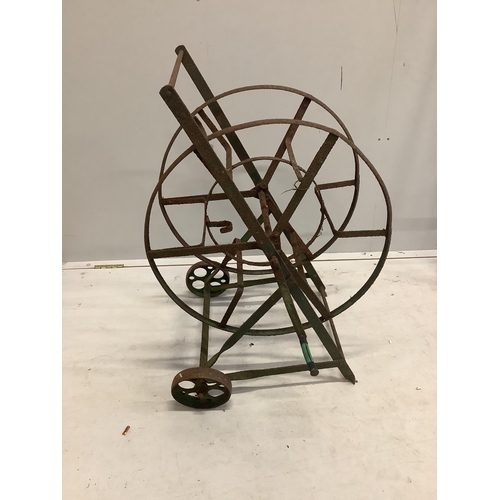 94 - A wrought iron boot scraper, height 122cm together with a hose reel stand. Condition - poor to fair... 