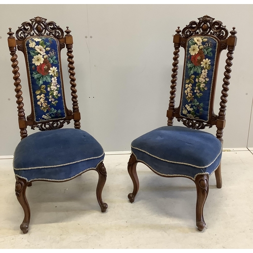 1014 - A pair of Victorian carved walnut side chairs with polychrome floral upholstered backs, width 46cm, ... 