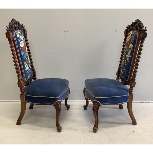 1014 - A pair of Victorian carved walnut side chairs with polychrome floral upholstered backs, width 46cm, ... 