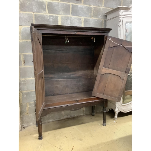 1016 - A mid 18th century carved oak cupboard, on associated stand, a.f., width 130cm, depth 55cm, height 1... 